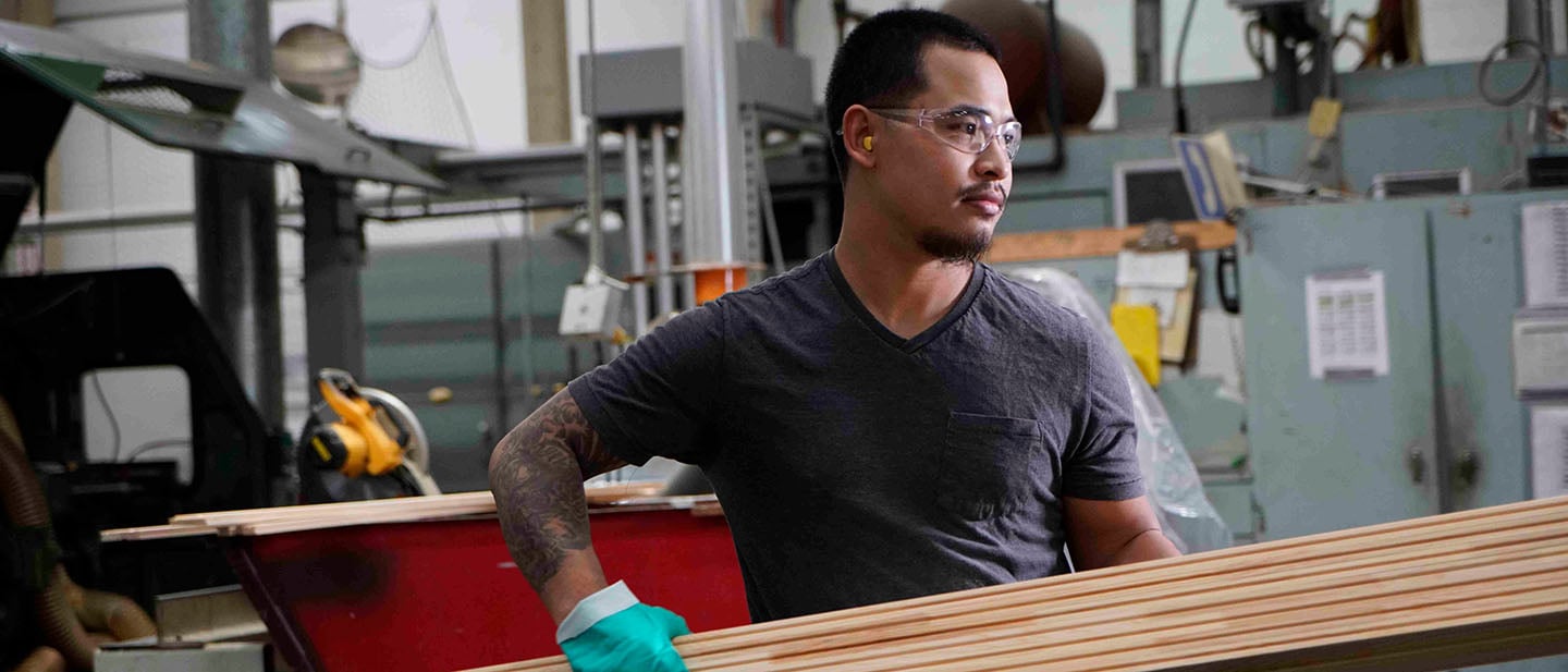 andersen employee carrying wood