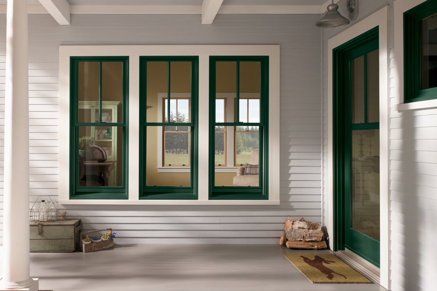 A farmhouse porch with Andersen 400 Series Double-Hung Windows.