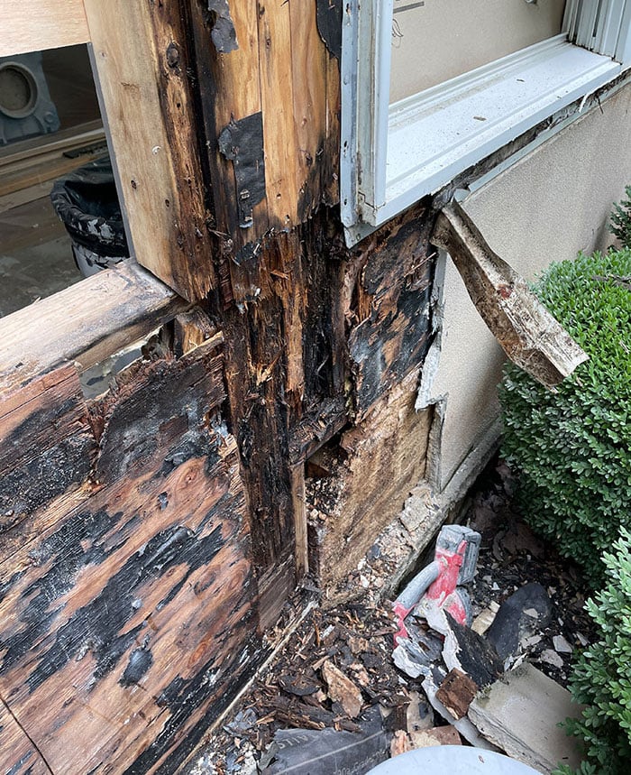 frame and surrounding stucco are improperly sealed. There are gaps and cracks visible between the frame and the stucco, which suggest further vulnerability to moisture. The wear and tear are apparent, and the window seems to lack proper caulking or flashing to prevent water ingress.