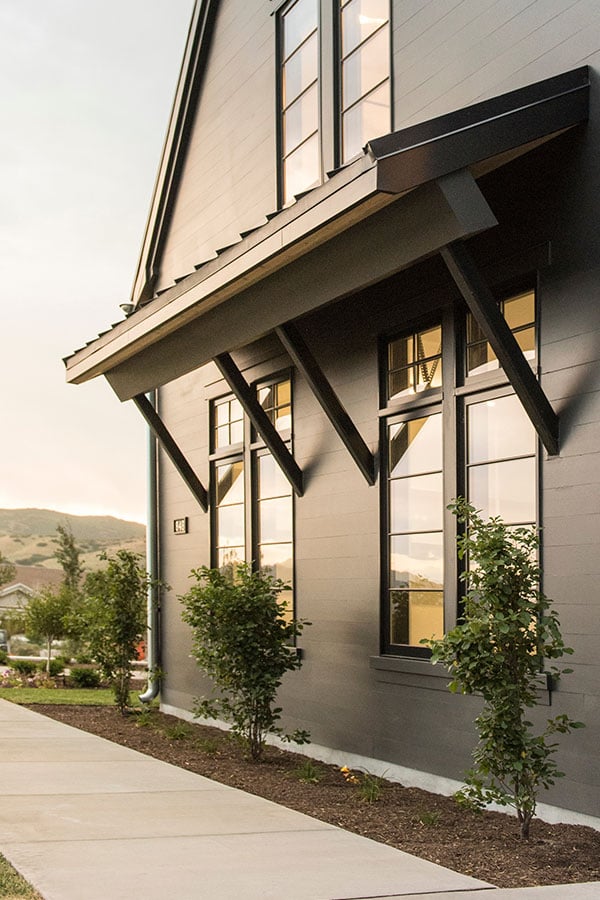 An exterior shot of a home with an overhang above the windows.