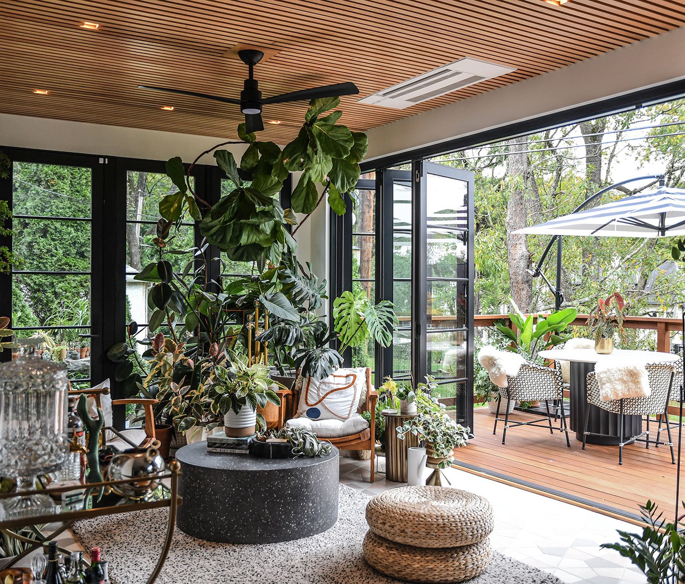 An indoor/outdoor space with a 14-foot tall LiftSlide Door that seamlessly connects a living room with outdoor pool area.