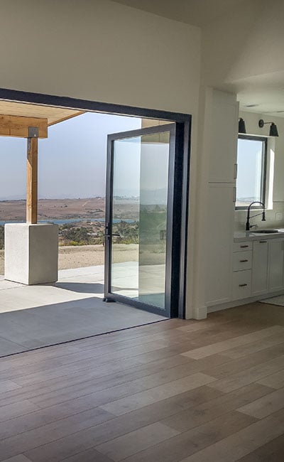 cropped view of black frame patio door opening to outside