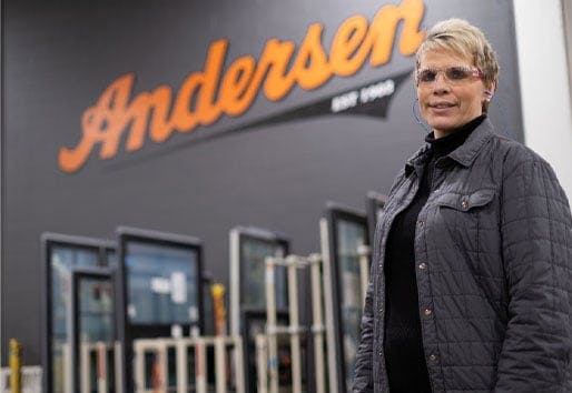 woman standing in manufacturing plant in front of andersen sign