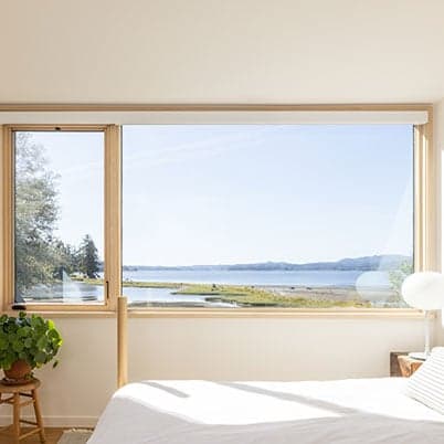 interior view of bedroom with andersen window looking out to ocean view