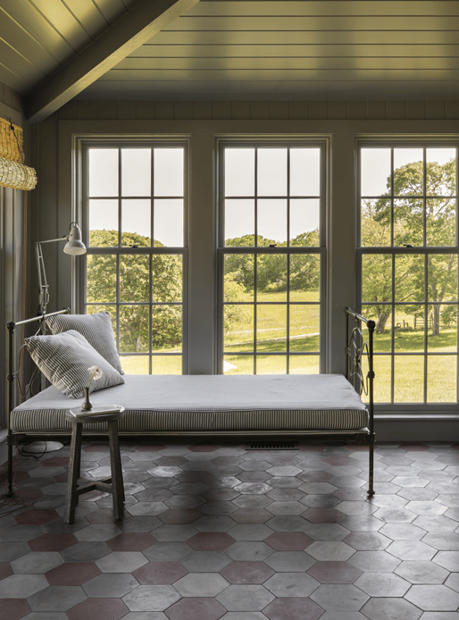 Cottage sunroom with wall to wall windows with grilles
